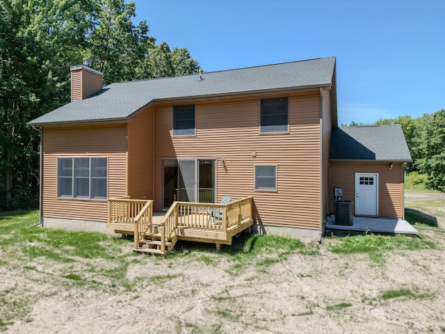 rear view of house with a deck and central air condition unit