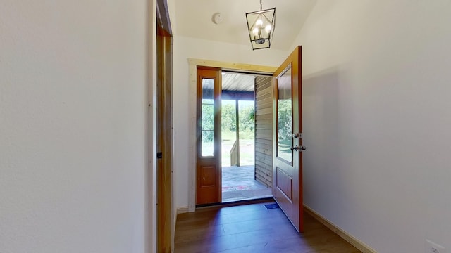 entryway featuring dark hardwood / wood-style flooring and a chandelier