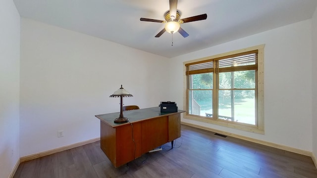 home office featuring dark hardwood / wood-style floors and ceiling fan