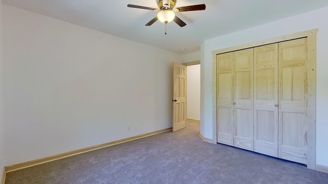 unfurnished bedroom with carpet, ceiling fan, and a closet