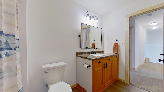 bathroom featuring vanity, a shower with shower curtain, and toilet