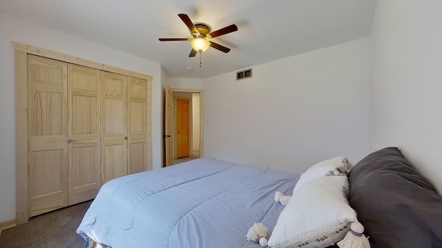 carpeted bedroom with a closet and ceiling fan