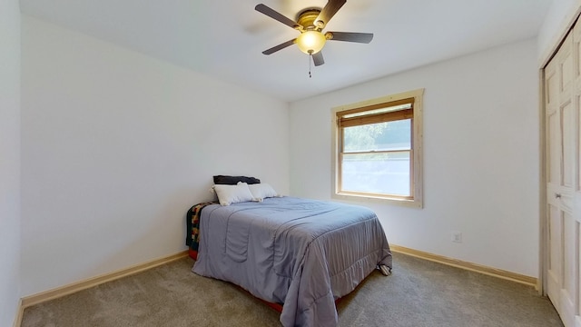 bedroom with light carpet, ceiling fan, and a closet