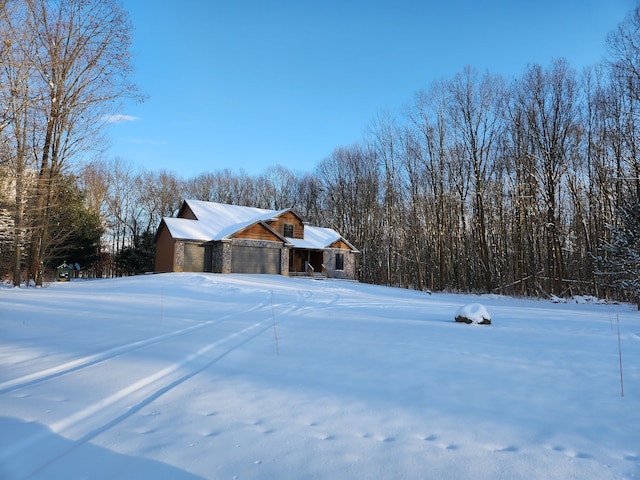 snow covered property with a garage