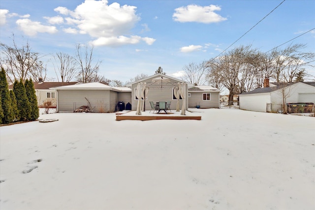 view of snow covered back of property