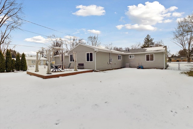 view of snow covered back of property