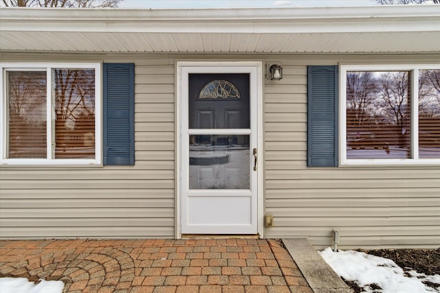 view of snow covered property entrance