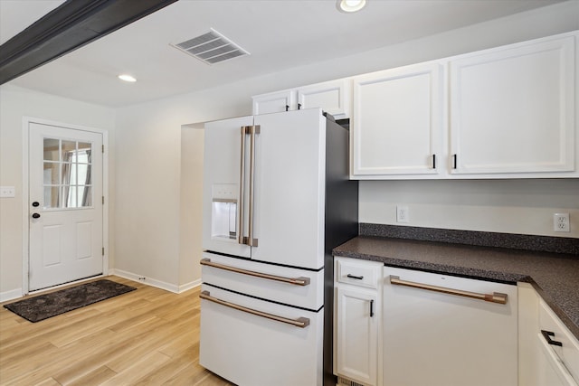 kitchen with white cabinets, white appliances, and light hardwood / wood-style flooring