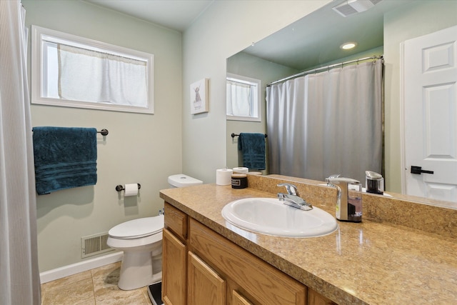 bathroom with vanity, tile patterned floors, and toilet