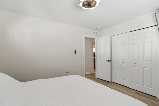 unfurnished bedroom featuring a closet and light wood-type flooring