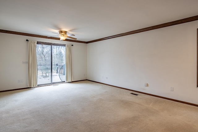 unfurnished room featuring a ceiling fan, light colored carpet, crown molding, and baseboards