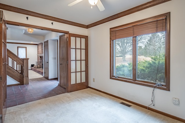 unfurnished room with visible vents, ornamental molding, carpet flooring, ceiling fan, and baseboards