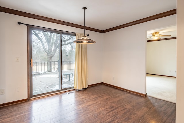 empty room featuring baseboards, dark wood finished floors, visible vents, and crown molding