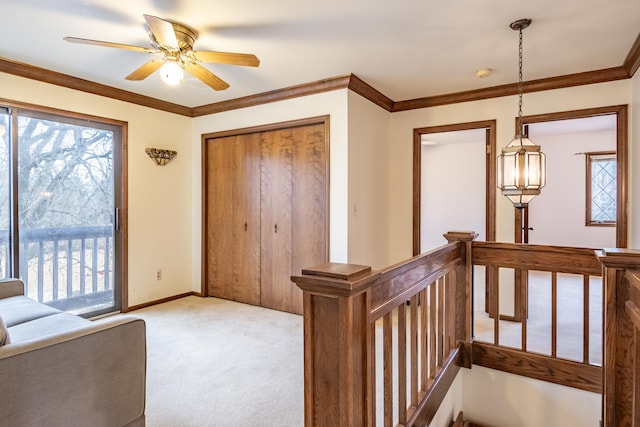 interior space featuring plenty of natural light, light colored carpet, crown molding, and an upstairs landing