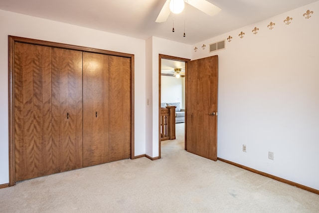 unfurnished bedroom featuring light carpet, baseboards, visible vents, a ceiling fan, and a closet