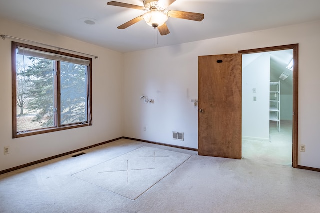 spare room featuring visible vents, ceiling fan, light carpet, and baseboards