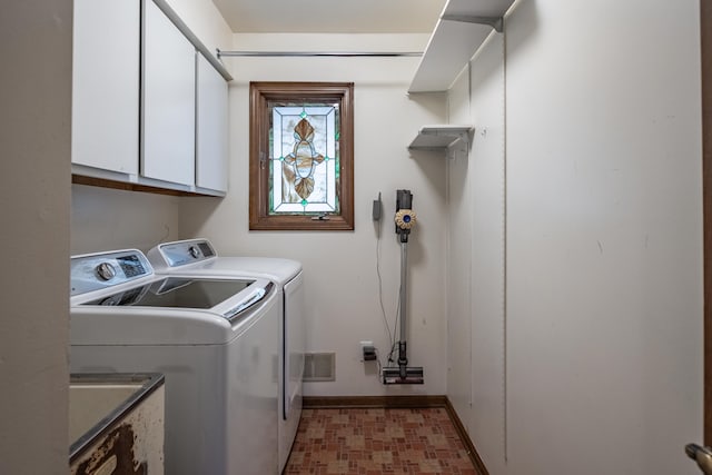 laundry area with light floors, cabinet space, washing machine and dryer, a sink, and baseboards