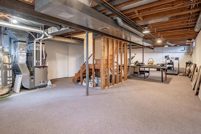 unfinished basement featuring carpet flooring and heating unit