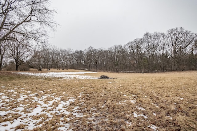 exterior space featuring a wooded view