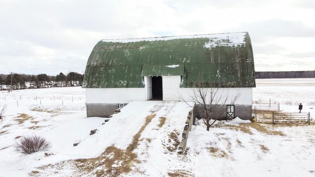 view of snow covered exterior with an outbuilding