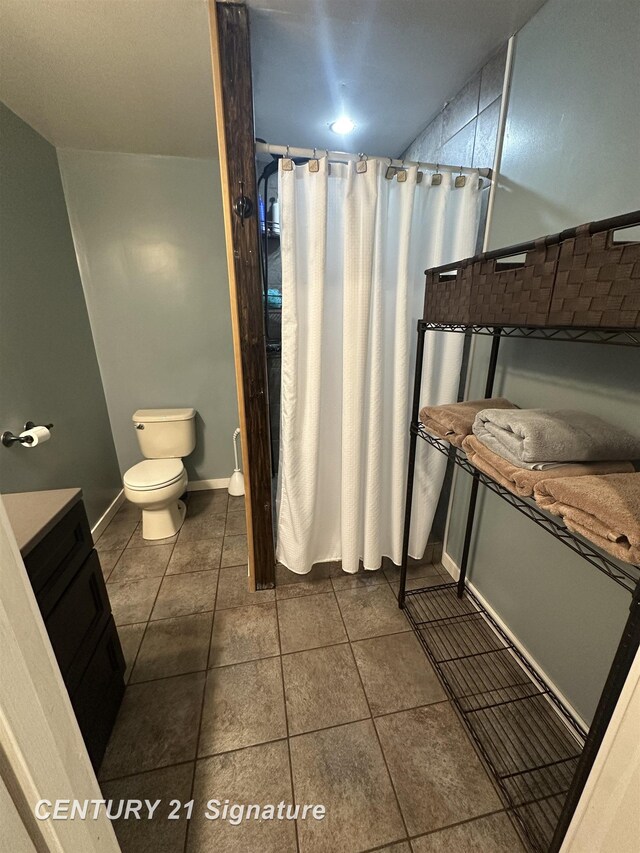 bathroom with vanity, toilet, and tile patterned flooring