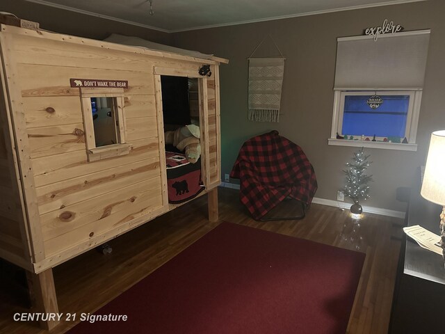 bedroom with crown molding and hardwood / wood-style flooring