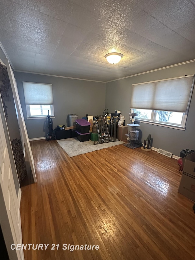 interior space with hardwood / wood-style flooring and ornamental molding