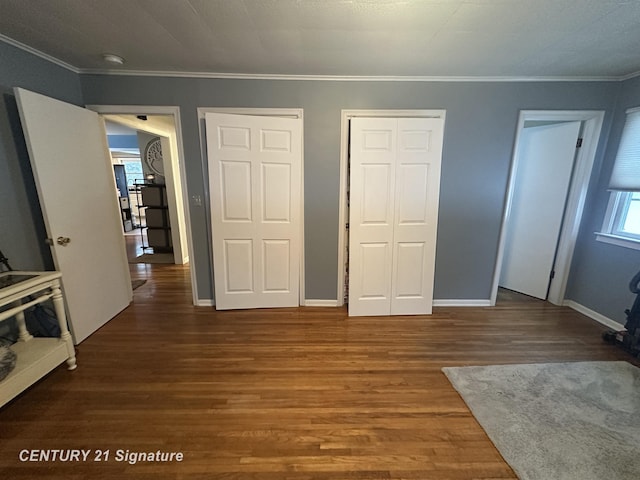 unfurnished bedroom featuring hardwood / wood-style flooring and crown molding