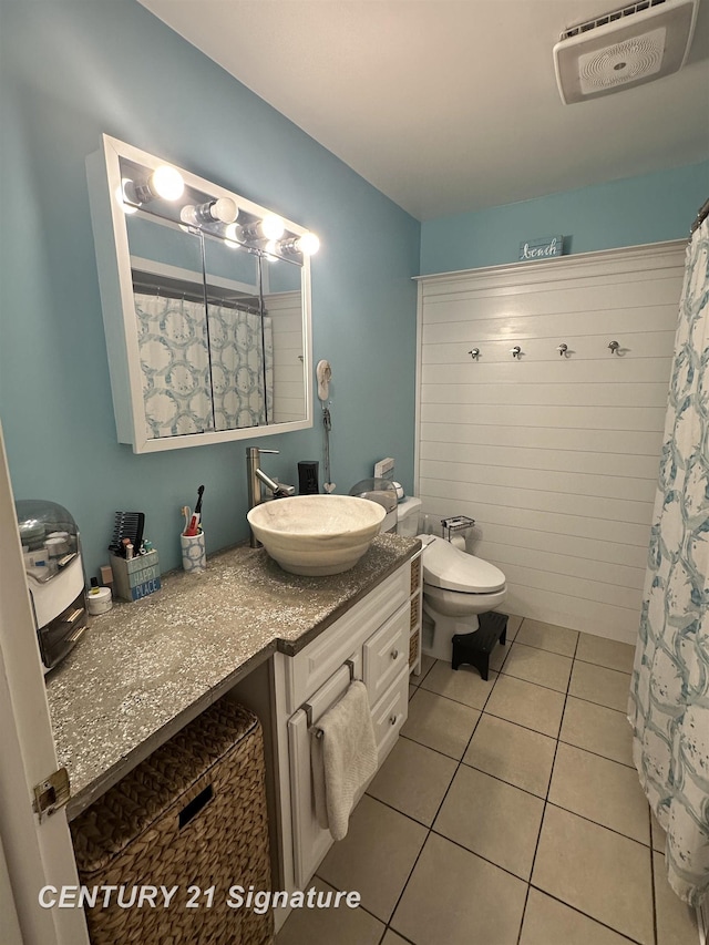 bathroom with vanity, tile patterned floors, and toilet