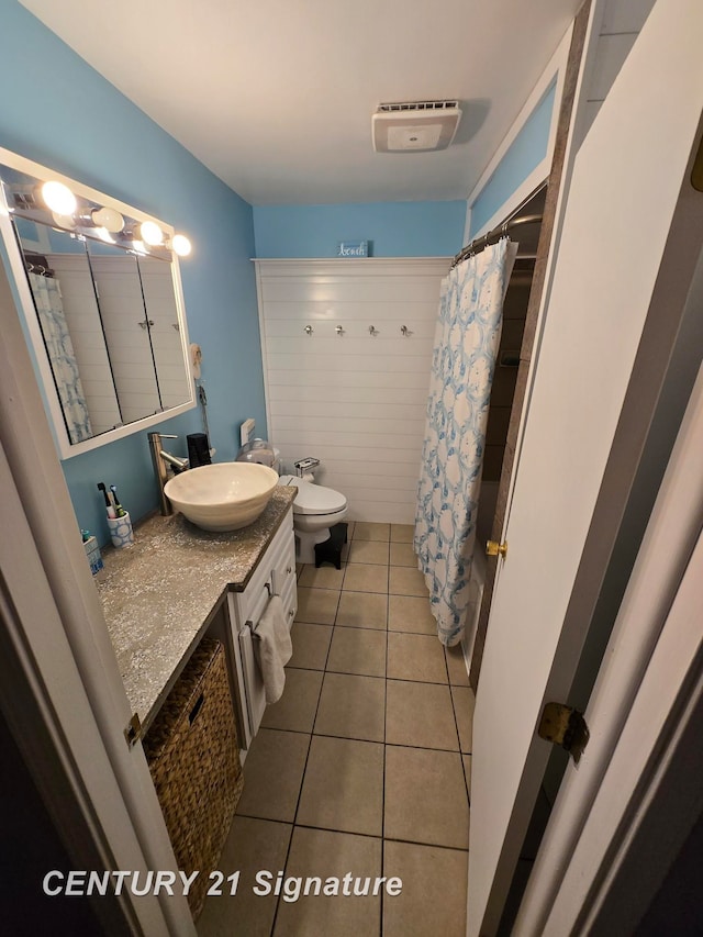 bathroom featuring tile patterned floors, toilet, and vanity