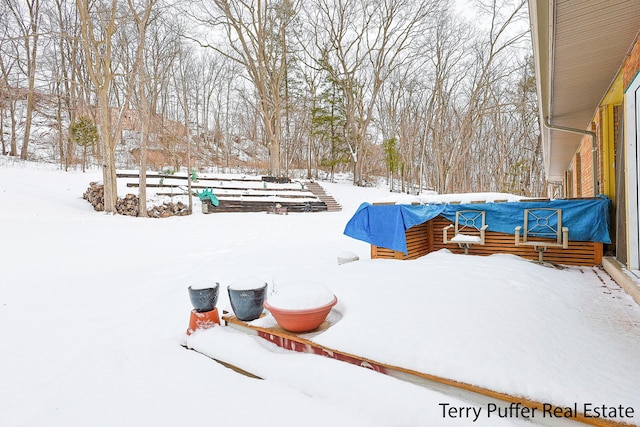 view of yard layered in snow