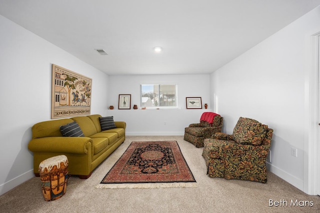 carpeted living room with visible vents and baseboards