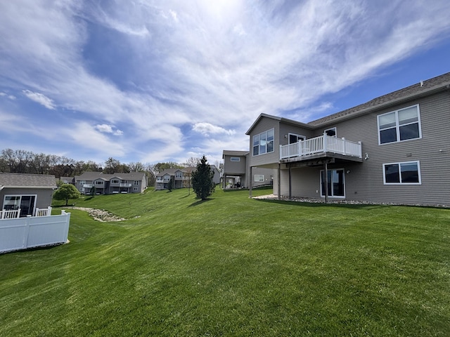 view of yard featuring a wooden deck and a residential view