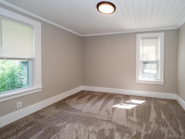 spare room with wood ceiling, ornamental molding, and carpet