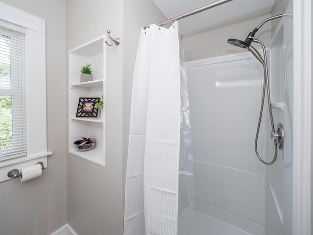 bathroom featuring curtained shower and built in features