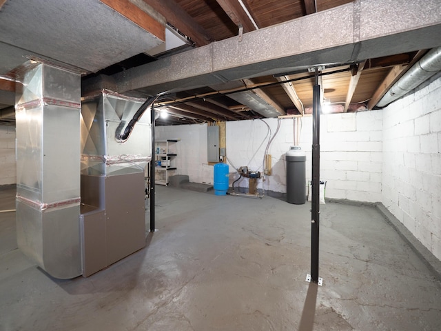 basement featuring electric panel and heating unit