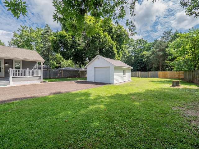 view of yard featuring a garage and an outdoor structure