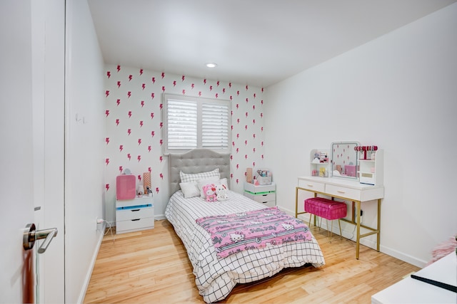 bedroom with hardwood / wood-style flooring