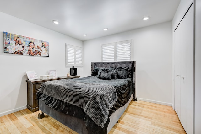 bedroom featuring light hardwood / wood-style floors and a closet