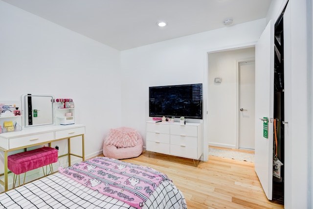 bedroom with hardwood / wood-style floors