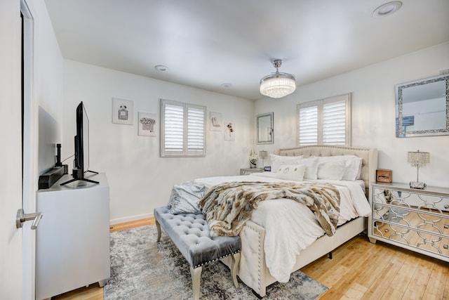 bedroom with multiple windows and light wood-type flooring