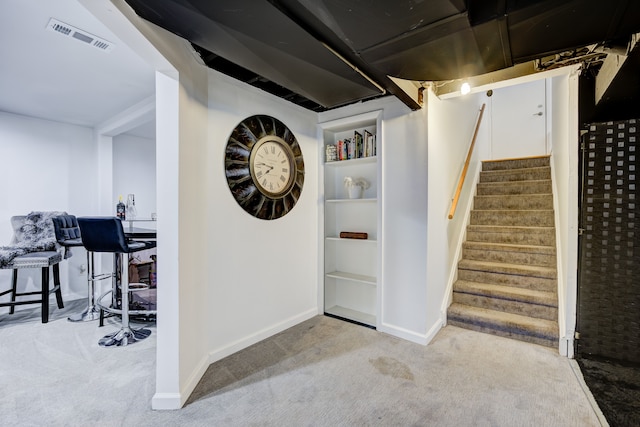 interior space featuring light carpet