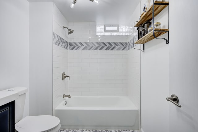 bathroom featuring tiled shower / bath and toilet