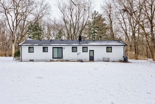 view of snow covered back of property