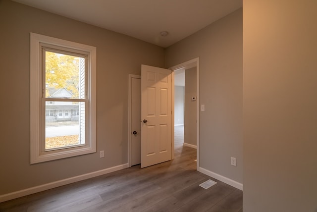 spare room featuring wood-type flooring