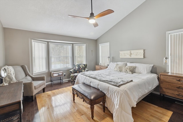 bedroom featuring hardwood / wood-style floors, high vaulted ceiling, a textured ceiling, and ceiling fan