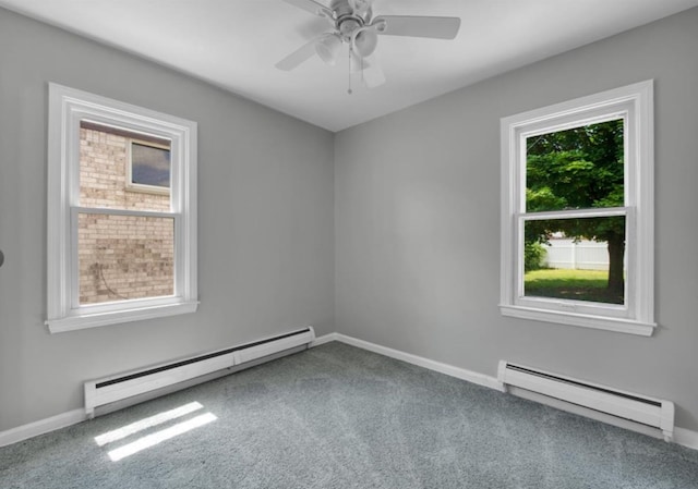 carpeted empty room with a baseboard heating unit, a wealth of natural light, and ceiling fan