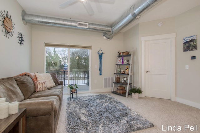 living room featuring ceiling fan and carpet