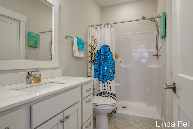 bathroom featuring vanity, toilet, and walk in shower