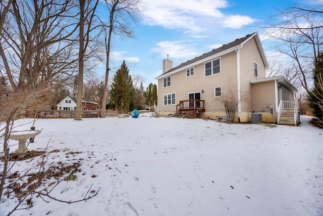 snow covered house with cooling unit